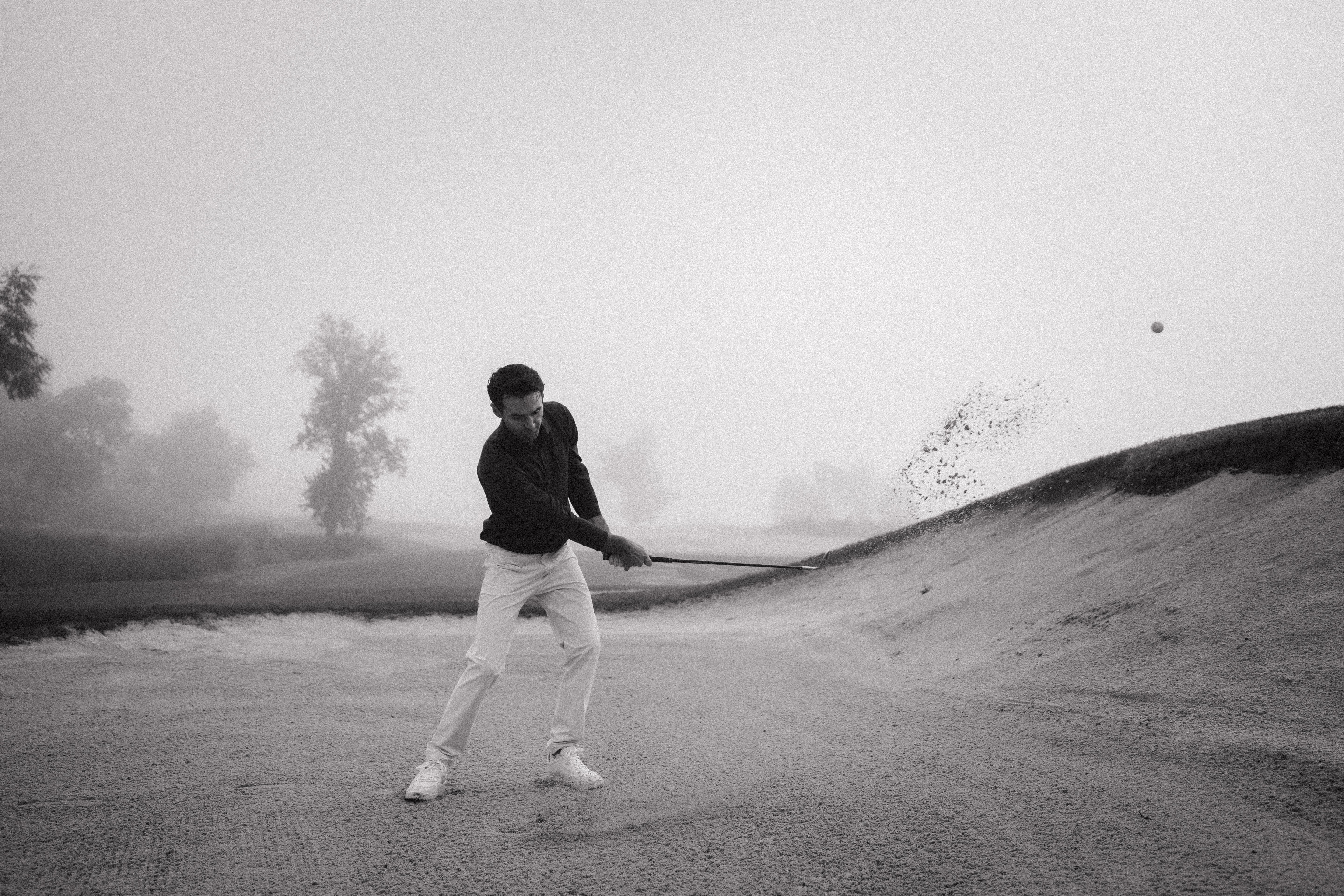 Golfer in a bunker on a foggy golf course - Olydoe Golf